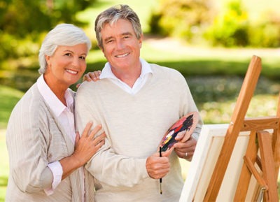 Senior couple painting a picture in a park