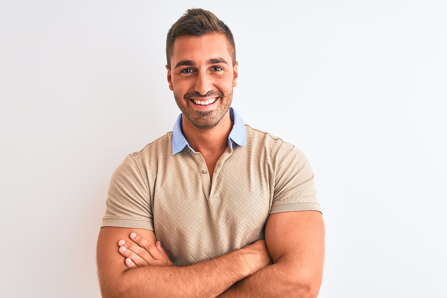 Young handsome man wearing elegant t-shirt over isolated background