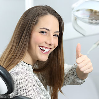 Young Woman With White Teeth Smiling in Office