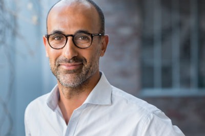 Portrait of happy mature man wearing spectacles and looking at camera outdoor