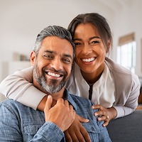 man and woman with white teeth smiling