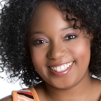 black woman with curly hair smiling