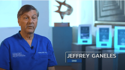 Photo of a male dentist in conversation gesture