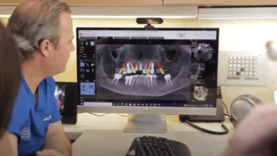 Dentists looking at x-rays on a computer