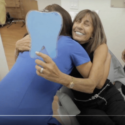 Female patient hugs the dentist Lili as a sign of gratitude