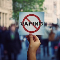 hand holding a no vaping sign