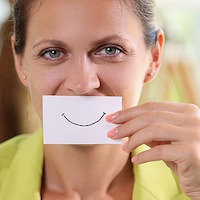 Portrait Of Woman Covering Face Using White Paper With Good Mood Smile Sign