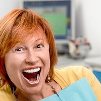 Middle aged woman with red hair smiling
